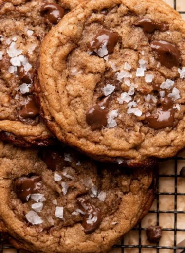 Freshly baked coffee cookies on a wooden table with coffee beans