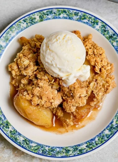 Delicious homemade apple crumble dessert topped with oats and cinnamon.