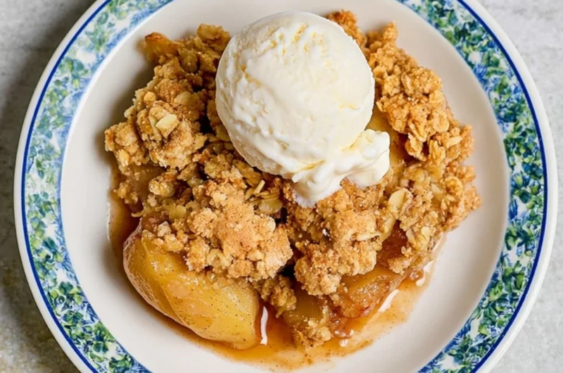 Delicious homemade apple crumble dessert topped with oats and cinnamon.