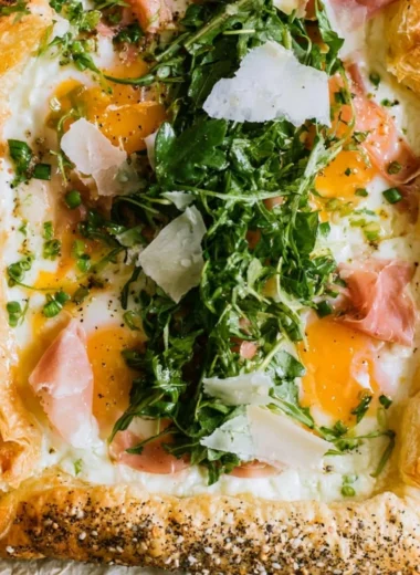Cozy baked prosciutto and egg breakfast tart on a wooden table