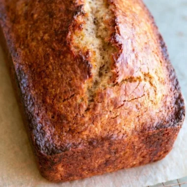 Sliced homemade banana bread with ripe bananas