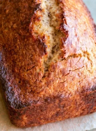 Sliced homemade banana bread with ripe bananas
