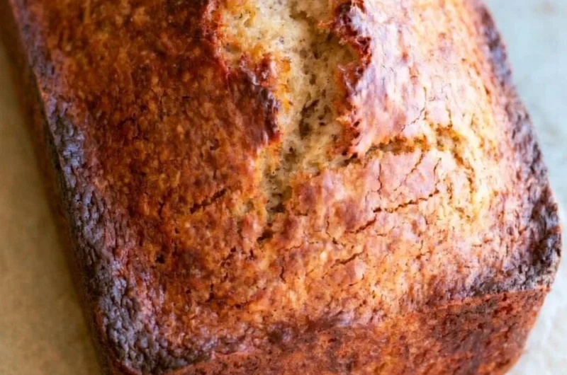 Sliced homemade banana bread with ripe bananas