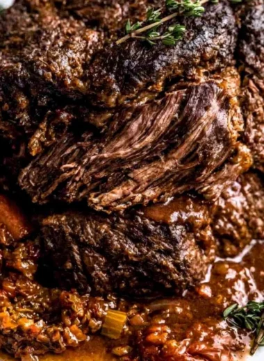 Delicious Ina Garten's Company Pot Roast served in a rustic bowl.