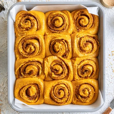 Homemade Pumpkin Cinnamon Rolls topped with cream cheese frosting