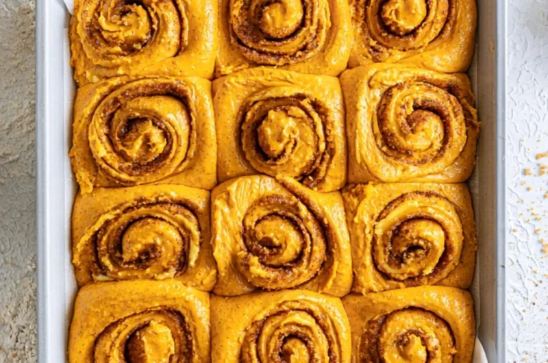 Homemade Pumpkin Cinnamon Rolls topped with cream cheese frosting