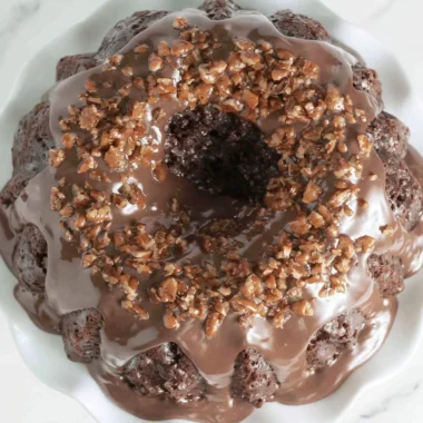 Texas Sheet Cake Bundt Cake showcasing a rich chocolate glaze and sprinkles.