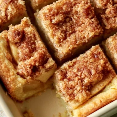 Cozy apple pie bars with a flaky crust and apple filling on a rustic wooden table