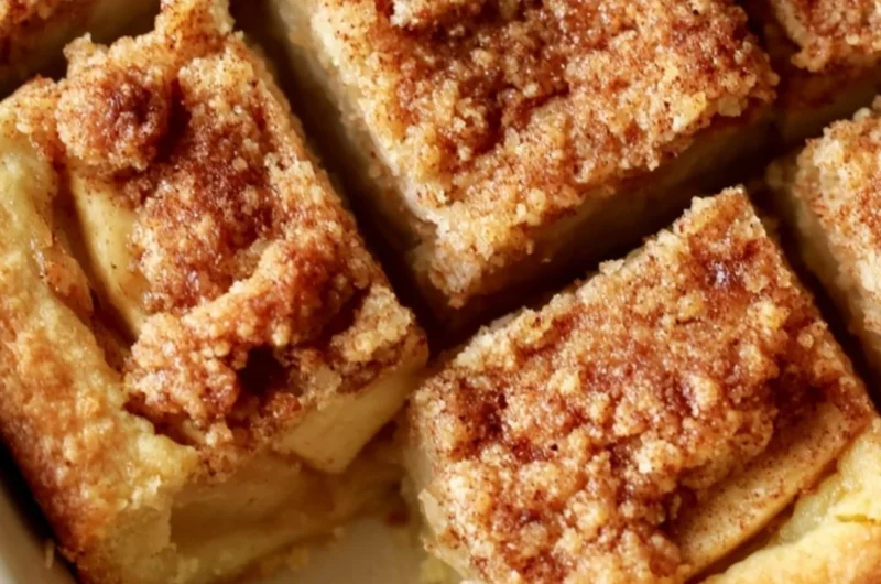 Cozy apple pie bars with a flaky crust and apple filling on a rustic wooden table