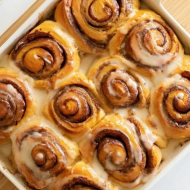 Freshly baked heavy whipping cream cinnamon rolls with icing.