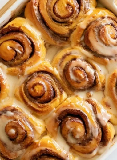 Freshly baked heavy whipping cream cinnamon rolls with icing.