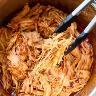 Delicious Instant Pot BBQ chicken served with sides on a cozy dining table.