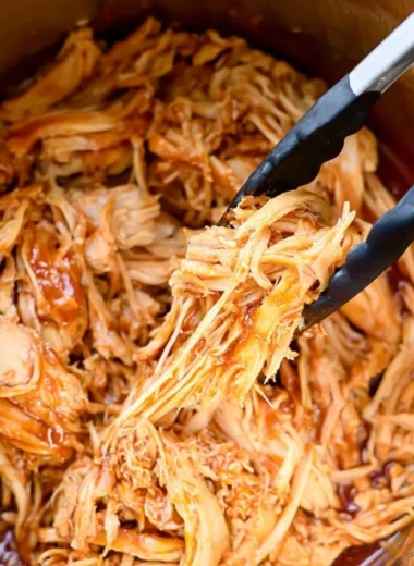 Delicious Instant Pot BBQ chicken served with sides on a cozy dining table.