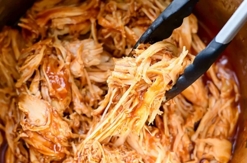 Delicious Instant Pot BBQ chicken served with sides on a cozy dining table.