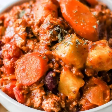 Bowl of cozy Turkey Apple Chili topped with fresh herbs and spices