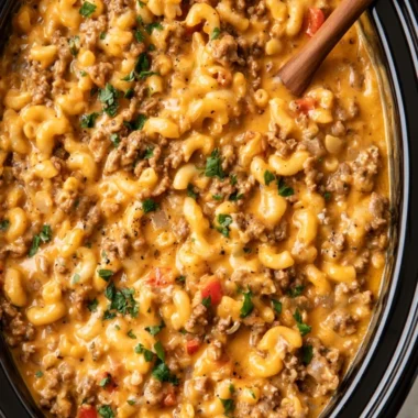 Slow cooker hamburger helper in a bowl with vegetables and cheese