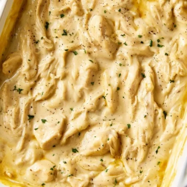 Delicious chicken and gravy served on a plate with fresh herbs.