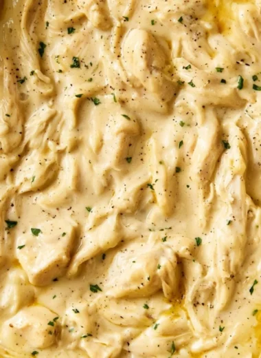 Delicious chicken and gravy served on a plate with fresh herbs.