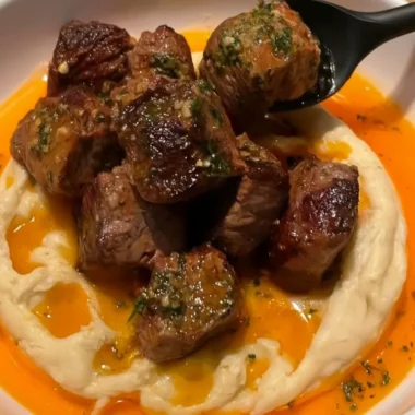 Delicious Cowboy Butter Steak Bites topped with caramelized onions.
