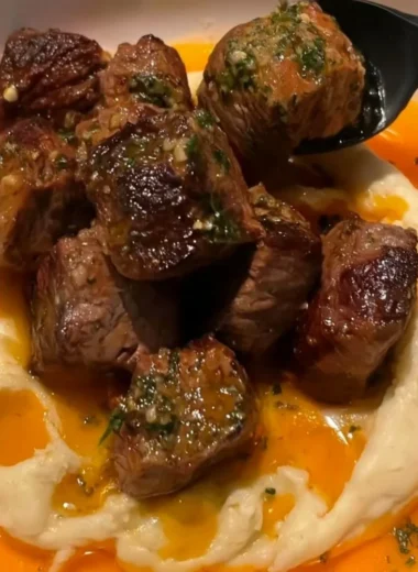Delicious Cowboy Butter Steak Bites topped with caramelized onions.