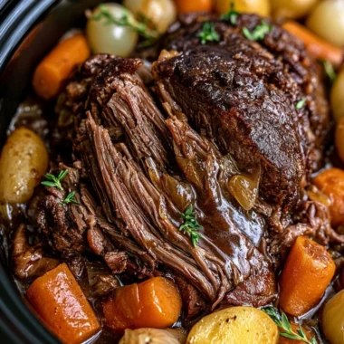 Cozy Crockpot pot roast served with vegetables and gravy.