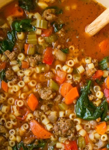 Cozy bowl of Italian sausage soup garnished with herbs for weeknight meals.