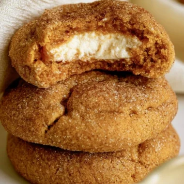 Chewy pumpkin cheesecake cookies fresh out of the oven, showcasing fall flavors.