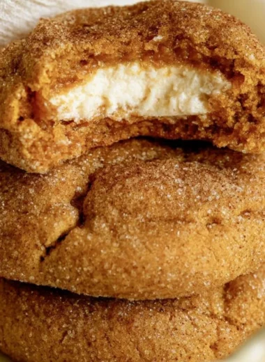 Chewy pumpkin cheesecake cookies fresh out of the oven, showcasing fall flavors.