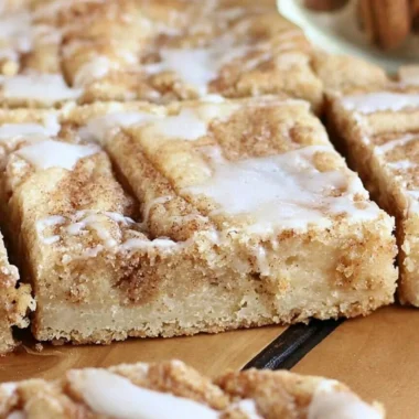 Delicious cinnamon roll cookie bars topped with icing from Sweet Girl Treats