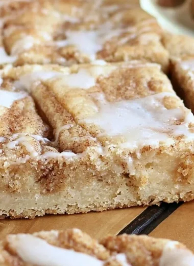 Delicious cinnamon roll cookie bars topped with icing from Sweet Girl Treats
