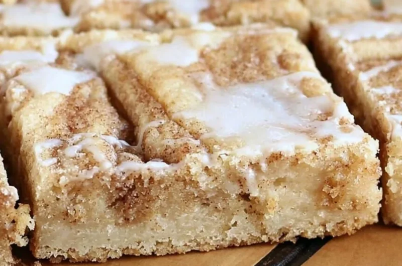 Delicious cinnamon roll cookie bars topped with icing from Sweet Girl Treats