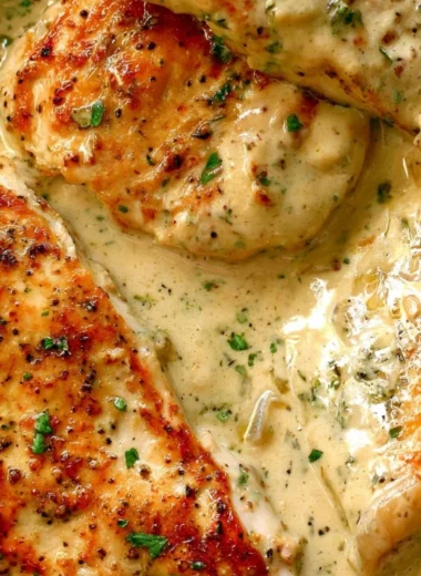 Creamy ranch chicken dish served on a plate with herbs and garnishes.