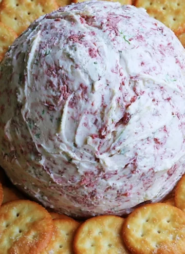 Easy party cheese ball served with crackers and fresh herbs