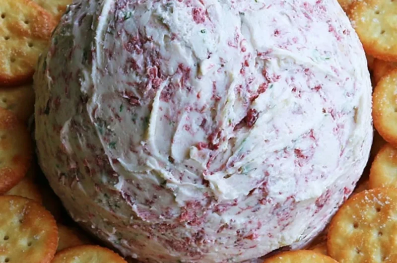 Easy party cheese ball served with crackers and fresh herbs
