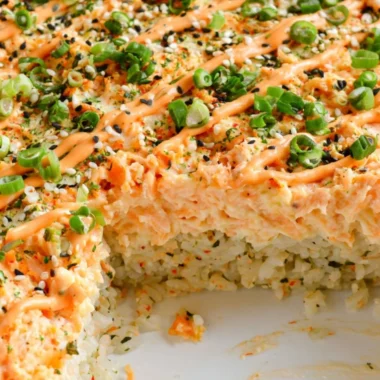 Baked Salmon Sushi topped with creamy avocado and sesame seeds
