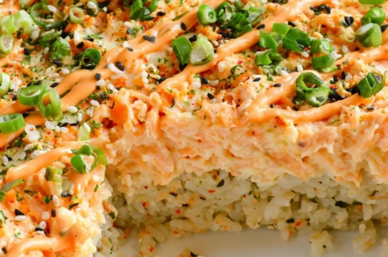 Baked Salmon Sushi topped with creamy avocado and sesame seeds