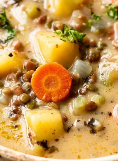 Bowl of vibrant Vegetarian Lentil Soup with fresh vegetables and herbs